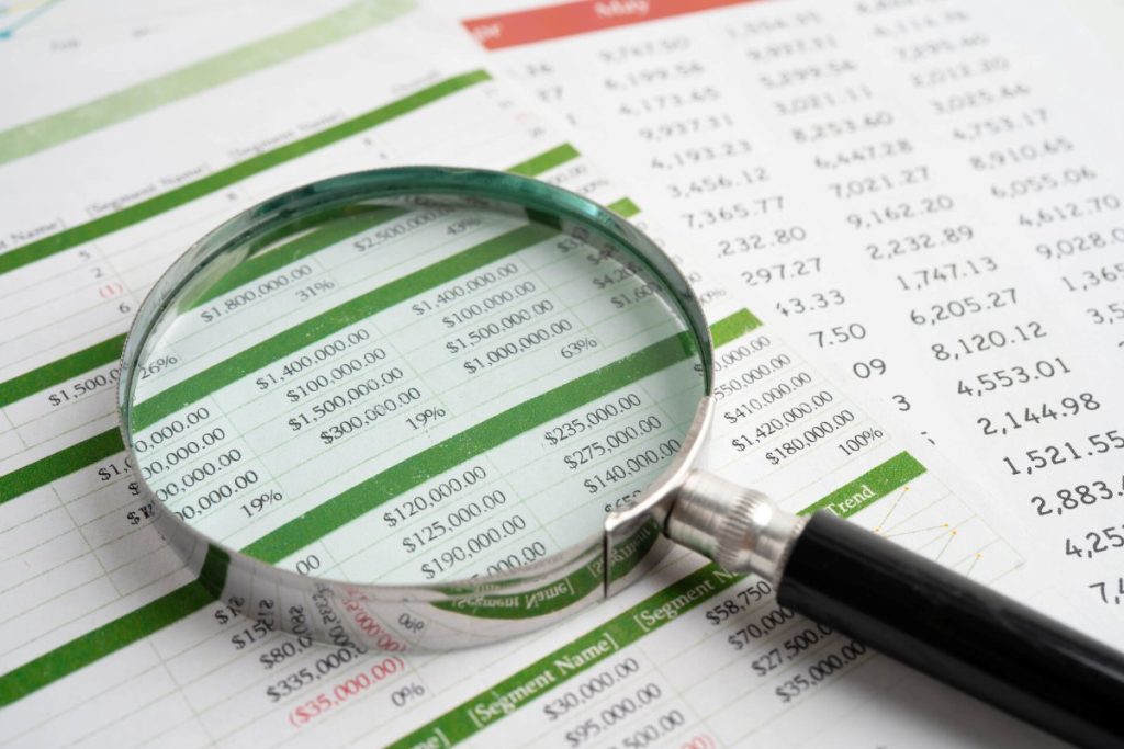 Magnifying glass on spreadsheet paper