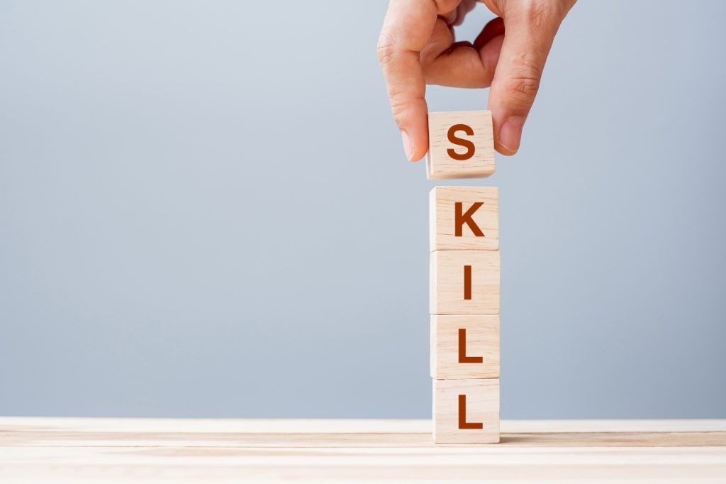 word skill spelled in wooden blocks